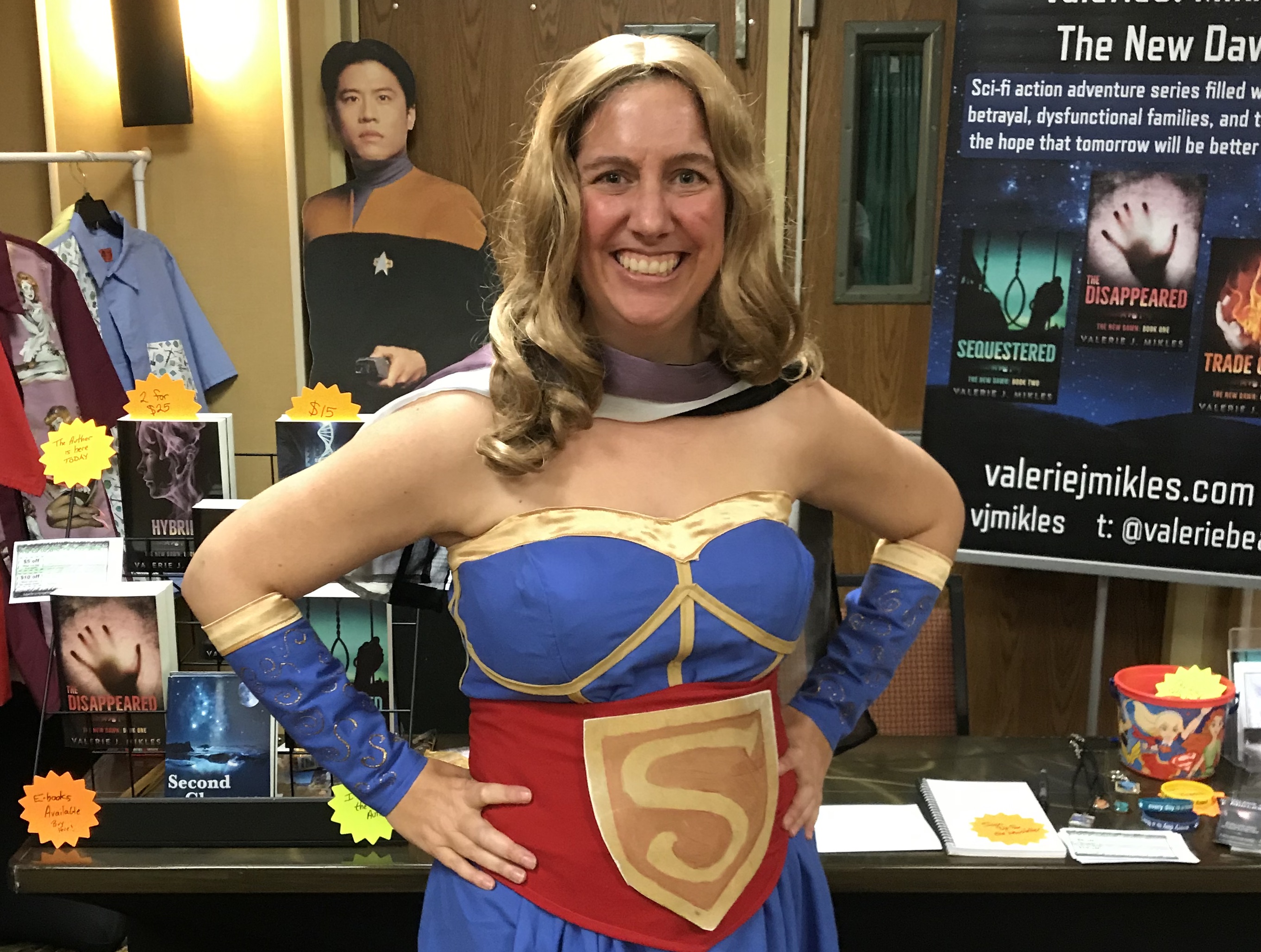 Me in a Supergirl costume and selling books
